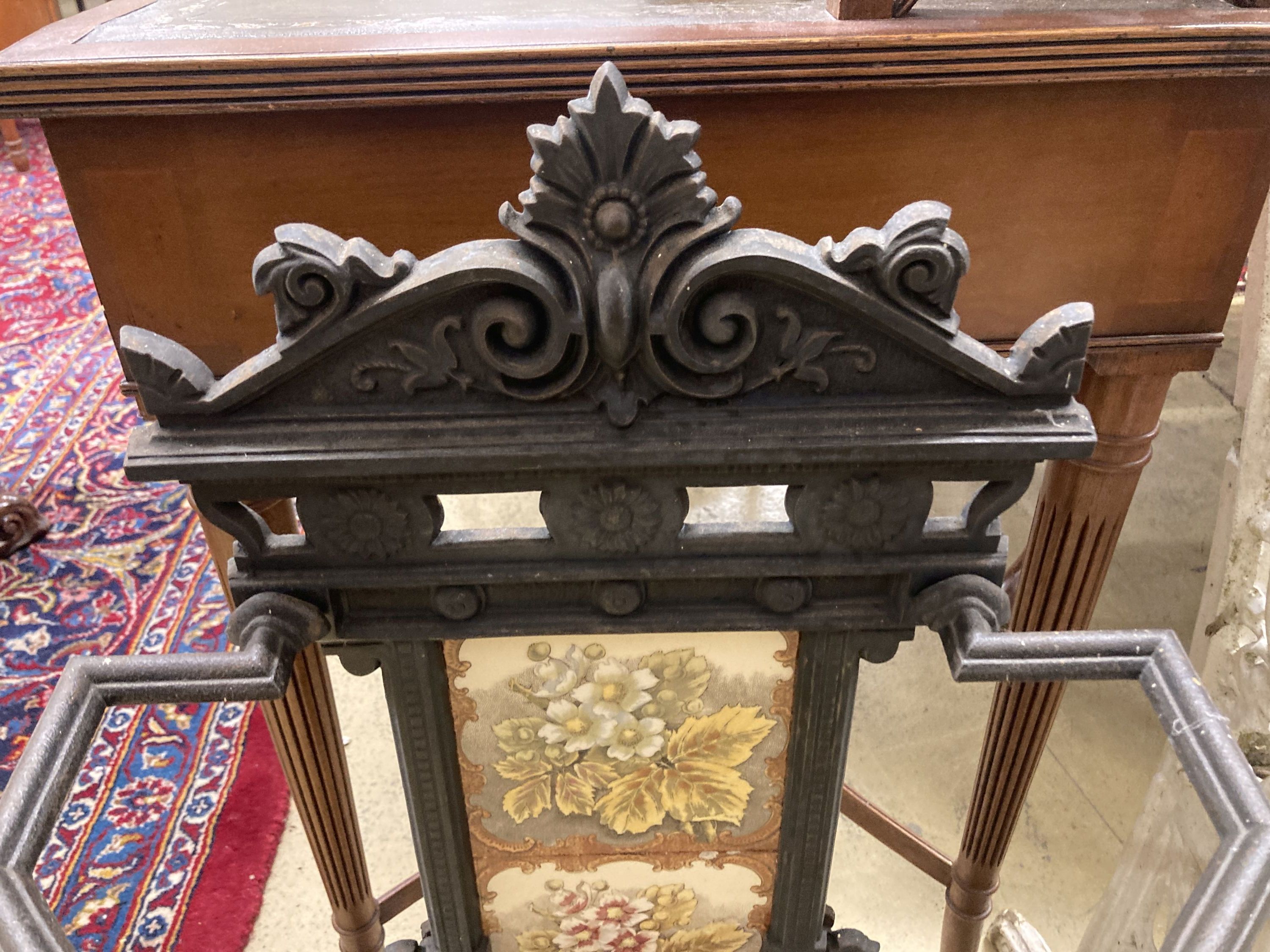 A Victorian style painted cast iron stick stand with tile inset back, width 40cm, depth 21cm, height 78cm